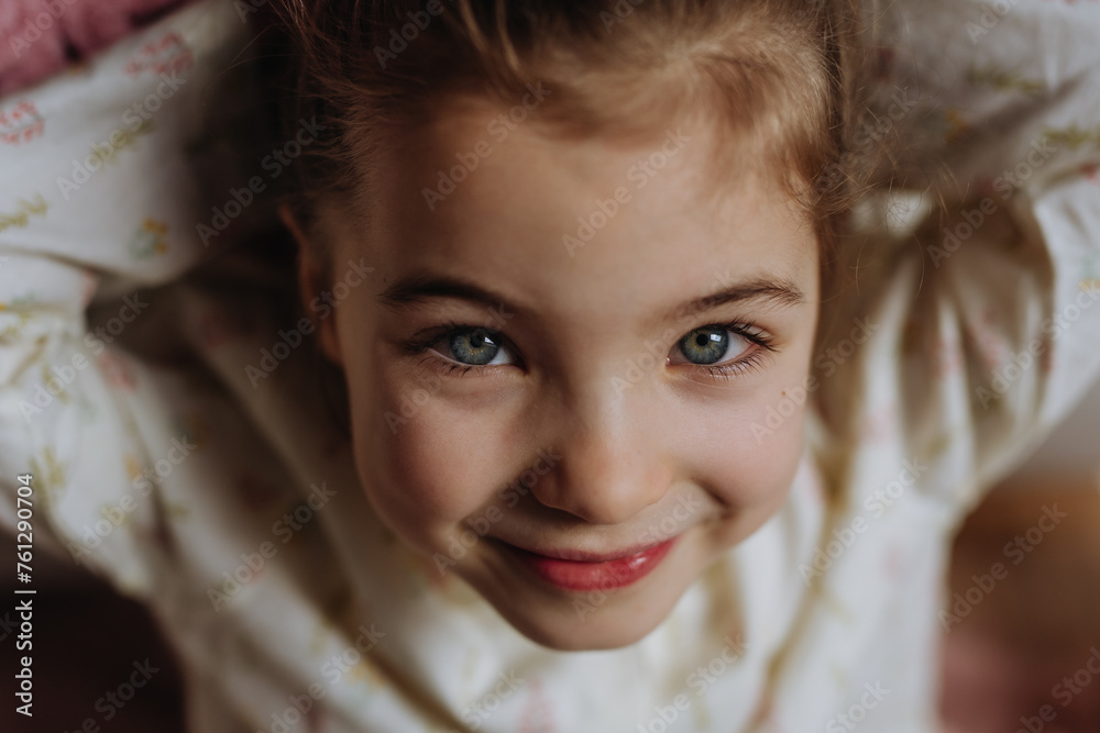 Top view portrait of little girl, charming young lady with beautiful eyes looking at the camera, smiling. Top view portrait of little girl, charming young lady with beautiful eyes looking at the camera, smiling.