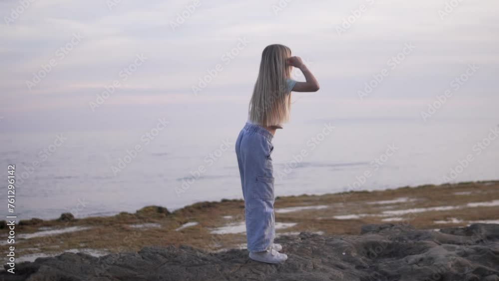Girl with long hair walking on the beach by the sea in the evening, Spain, Alicante Girl with long hair walking on the beach by the sea in the evening, Spain, Alicante