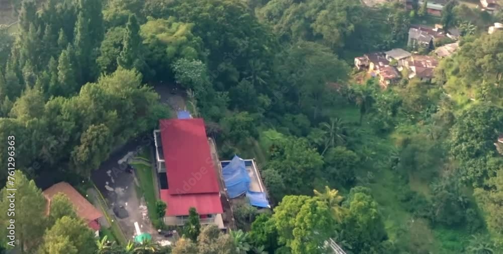 aerial video of dense trees and beautiful forests in a hilly area on a misty morning