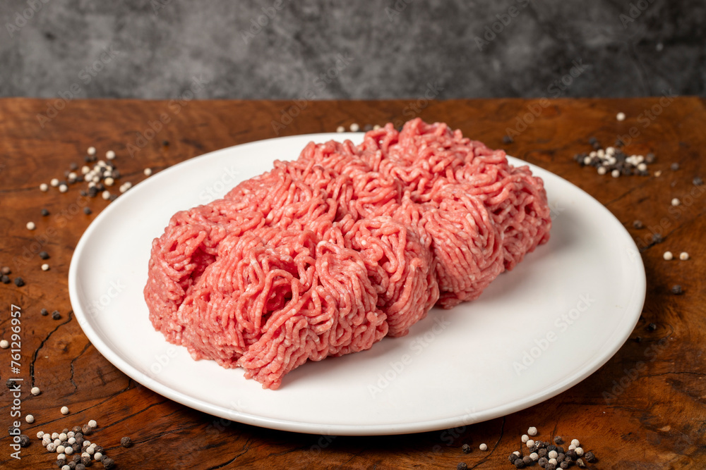 Ground beef. Butcher products. Fresh minced meat on dark background. Close up Ground beef. Butcher products. Fresh minced meat on dark background. Close up