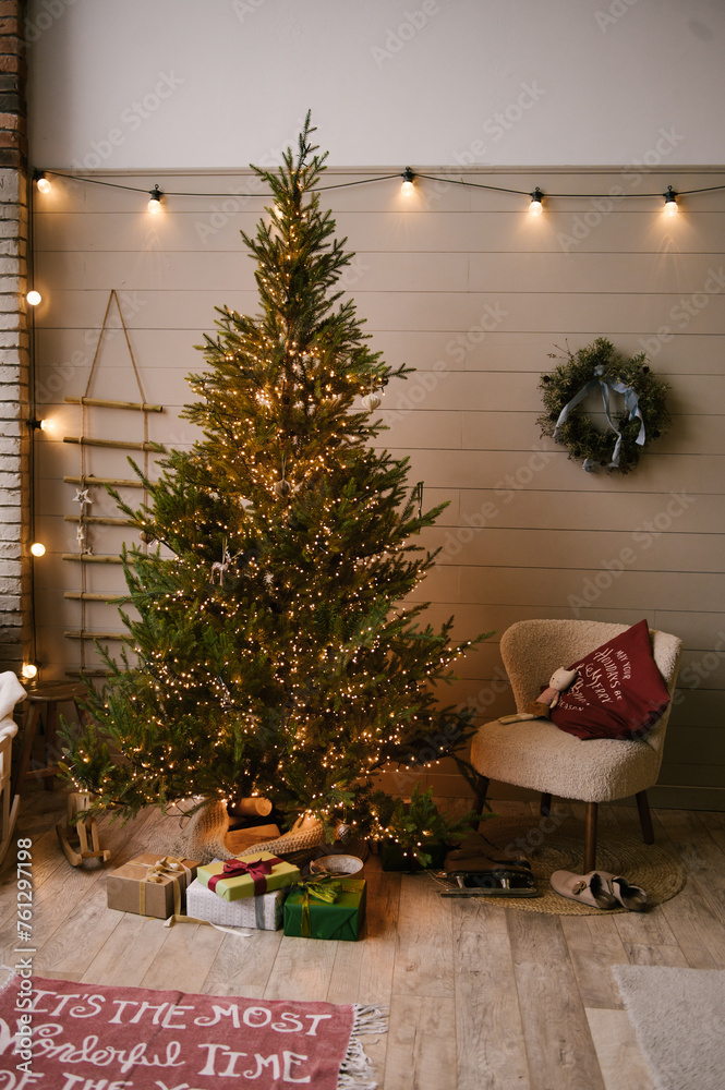 Beautiful New Year decor in a stylish interior with a Christmas tree, wreath and gifts