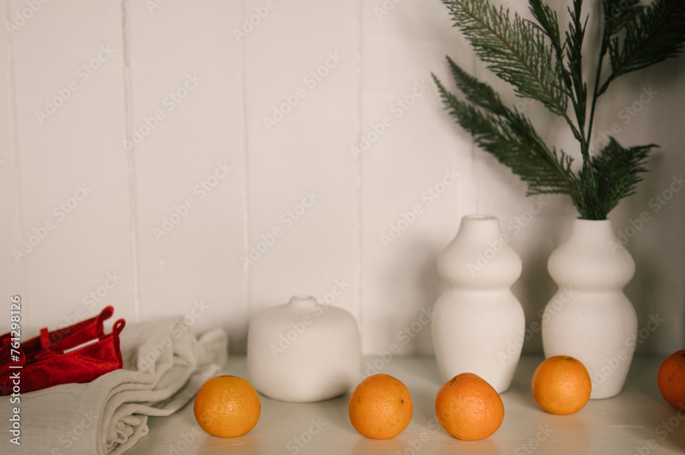 Stylish interior with a white sideboard and a Christmas tree decorated for the new year