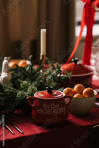 Obraz na płótnie Beautiful New Year decor, a Christmas table with a red tablecloth and candles, festive dishes and glasses w salonie