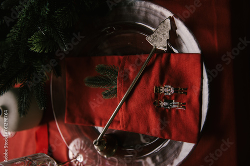 Obraz na płótnie Beautiful New Year decor, a Christmas table with a red tablecloth and candles, festive dishes and glasses w salonie