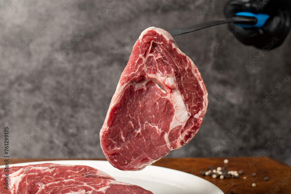 Raw beef ribeye meat. Butcher products. Fresh beef ribeye meat on dark background. Close up