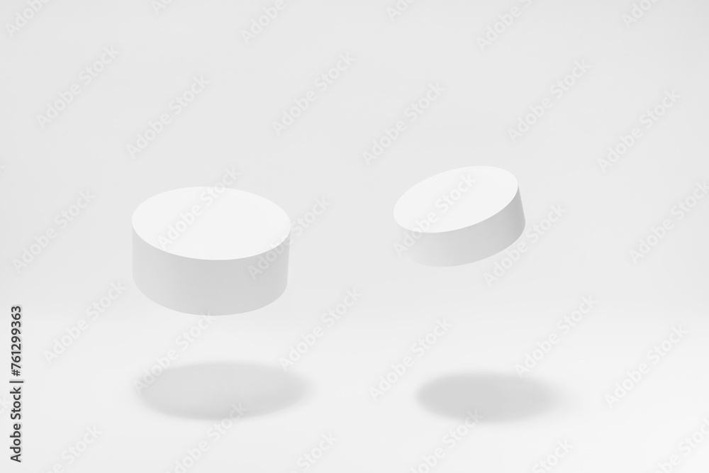 Set of two round tilt white podiums for cosmetic products mockup, soar in hard light, shadow on white background. Stage for presentation skin care products, gifts, goods, advertising, design, sale. Set of two round tilt white podiums for cosmetic products mockup, soar in hard light, shadow on white background. Stage for presentation skin care products, gifts, goods, advertising, design, sale.