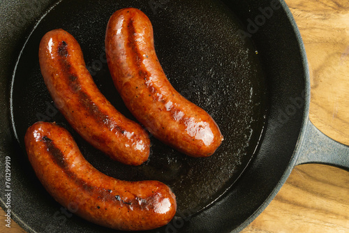 Pan frying precooked juicy smoked sausage with cast iron skillet