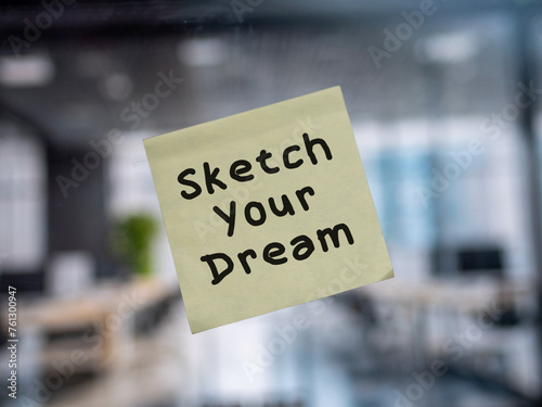 Post note on glass with 'Sketch Your Dream'.