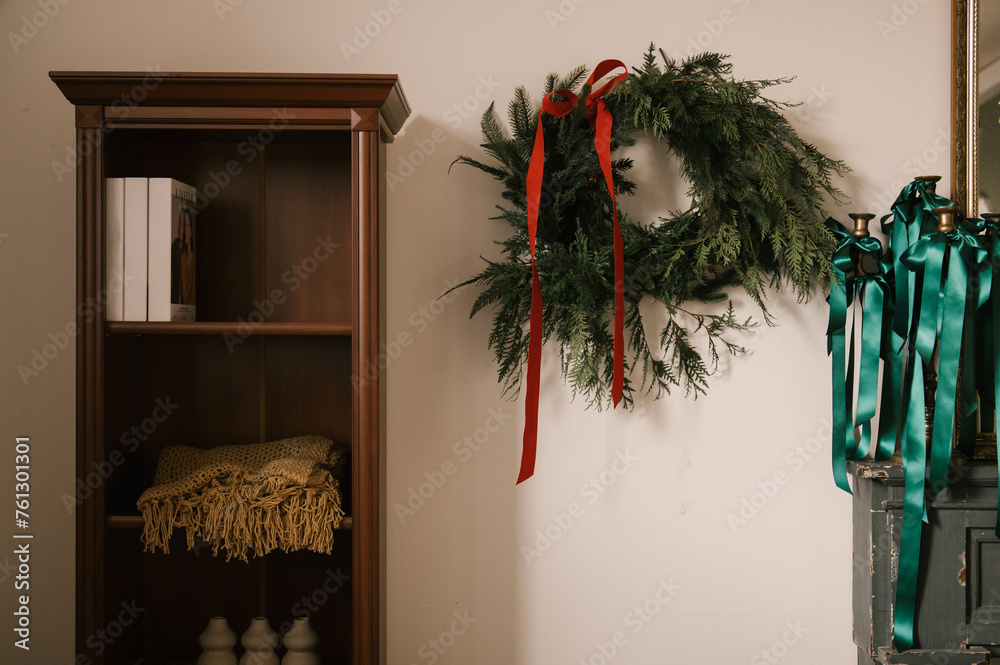 Stylish interior with a white sideboard and a Christmas tree decorated for the new year