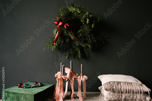 Obraz na płótnie Beautiful New Year decor, a Christmas wreath on a vintage chest of drawers in a stylish dark living room interior w salonie
