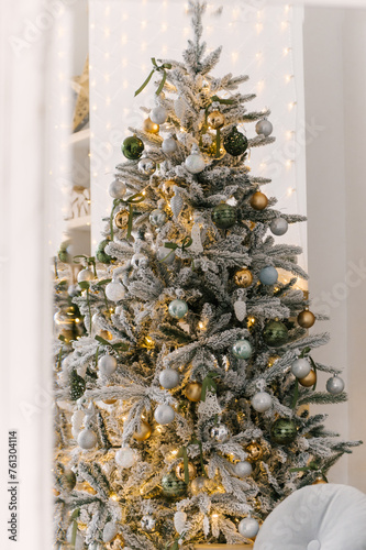 Obraz na płótnie Christmas decor, beautiful snow-covered Christmas tree with toys and lights w salonie