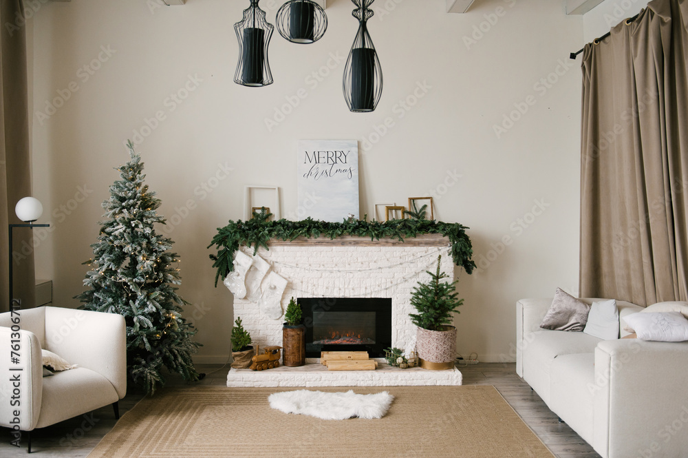Beautiful stylish modern interior with fireplace decorated for the new year with a Christmas tree