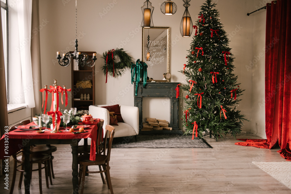 Beautiful New Year decor, the Christmas tree is decorated with red bows in the stylish interior of the living room