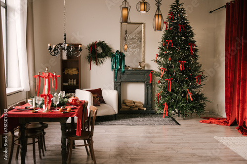 Obraz na płótnie Beautiful New Year decor, the Christmas tree is decorated with red bows in the stylish interior of the living room w salonie