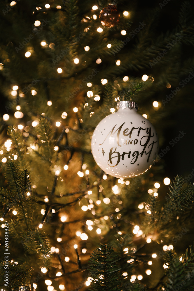 Beautiful New Year decor, Christmas tree in the stylish dark interior of the living room