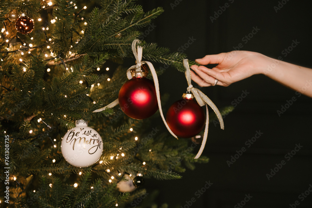 Beautiful New Year decor, Christmas tree in the stylish dark interior of the living room