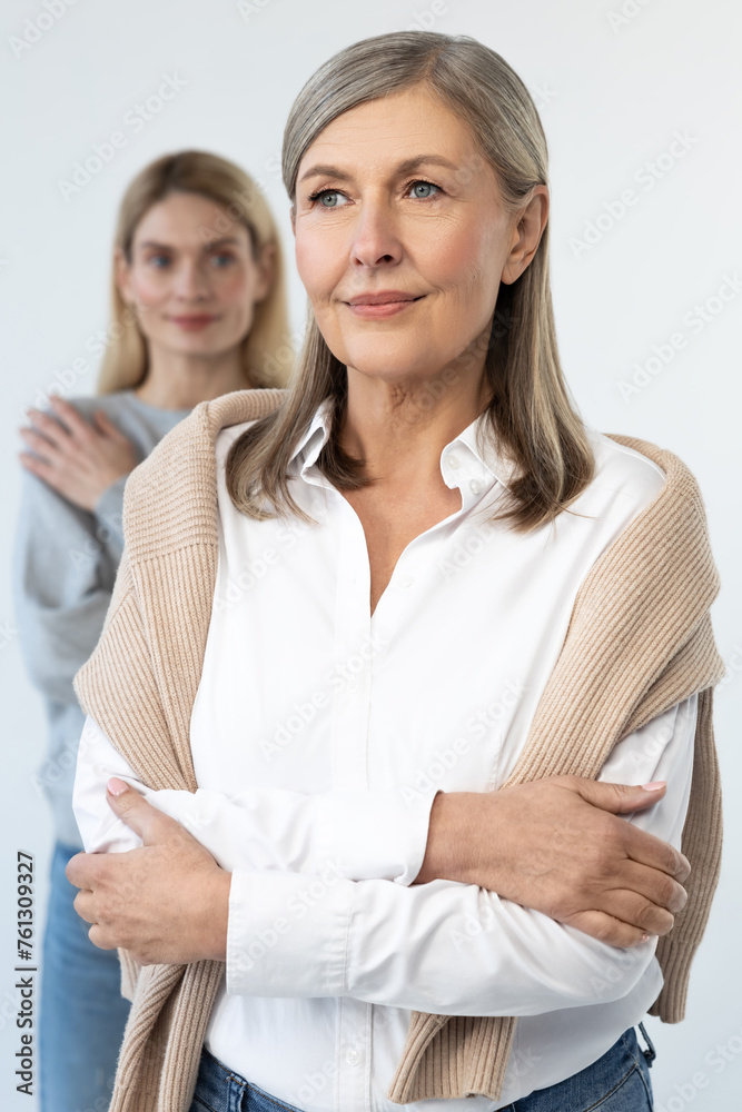 Good-looking mature well-groomed woman with her daughter Good-looking mature well-groomed woman with her daughter