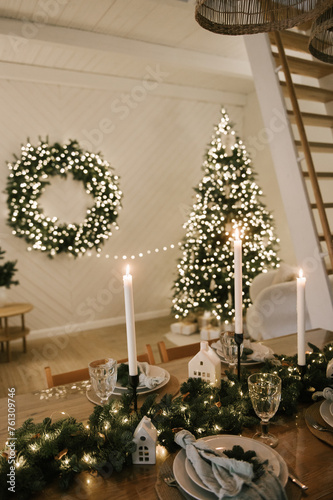 Obraz na płótnie Beautiful New Year's decor at home, the table is set for the holiday against the background of the lights of the Christmas tree w salonie