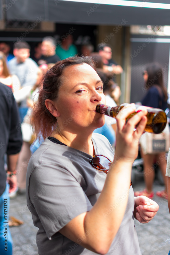 adult woman enjoying her drink at the town's festivals