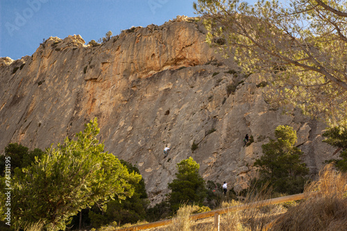 Mountain peaks and trees at the foot. Spain, Busot. sunny day. rock climbers photo