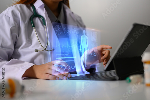 Doctor in uniform using digital tablet with electronic medical record on virtual screen. Medical technology concept