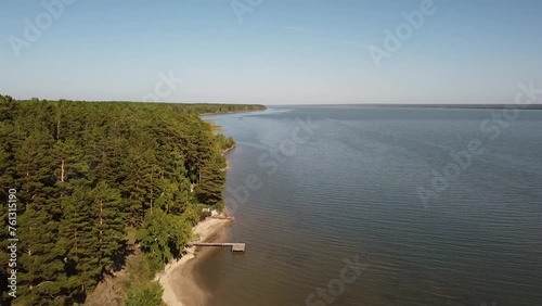 A drone flies along the bank of the siberian Ob River, drone footage.