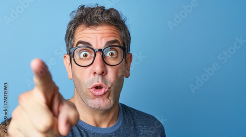 Enthusiastic man pointing on soft colored background with ample space for text placement