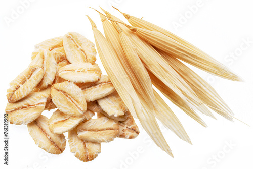 Dry oat plant florets and oat flakes isolated on white background. Macro shoot.