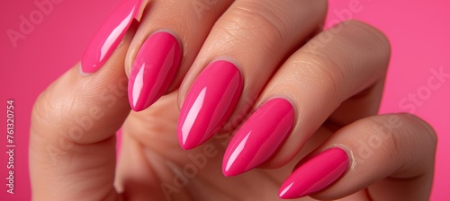 Elegant woman s hand with pink nail polish in close up  showcasing beautiful manicure