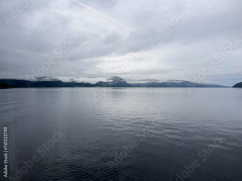 A scene of a ferry on a rainy day crossing the Sogn Fjord  Norway