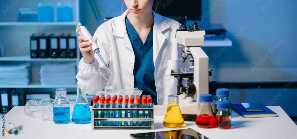 Modern medical research laboratory. female scientist working with micro pipettes analyzing biochemical samples, advanced science chemical laboratory .. Modern medical research laboratory. female scientist working with micro pipettes analyzing biochemical samples, advanced science chemical laboratory ..
