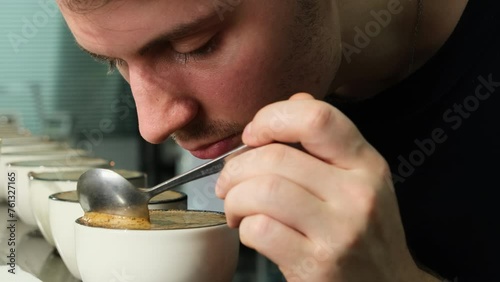 Coffee essence unfurls with man every stir in cup closeup. Skilled evaluator discerns subtle undertones bolding highlights characterizing blend photo