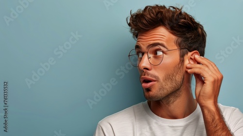 Man With Glasses Holding Ear © olegganko