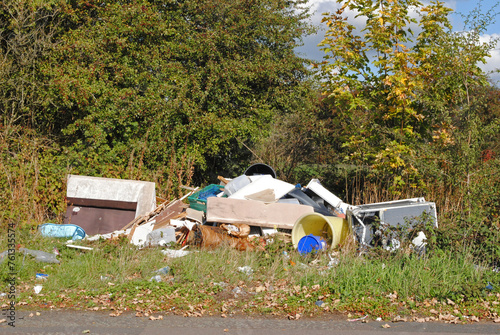 Waste Illegally Dumped beside Road on Summers Day 