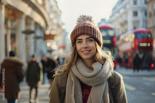 A woman with long hair and wearing a jacket, scarf and hat, while strolling through the city.