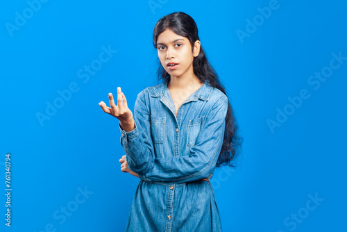 confused indian girl showing shrugging hand gesture photo