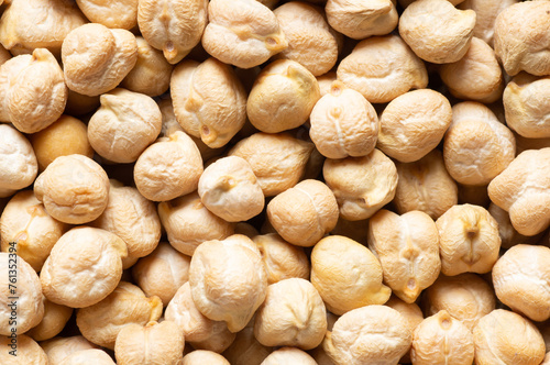 Uncooked dried chickpeas textured background. Heap of legume chickpea background