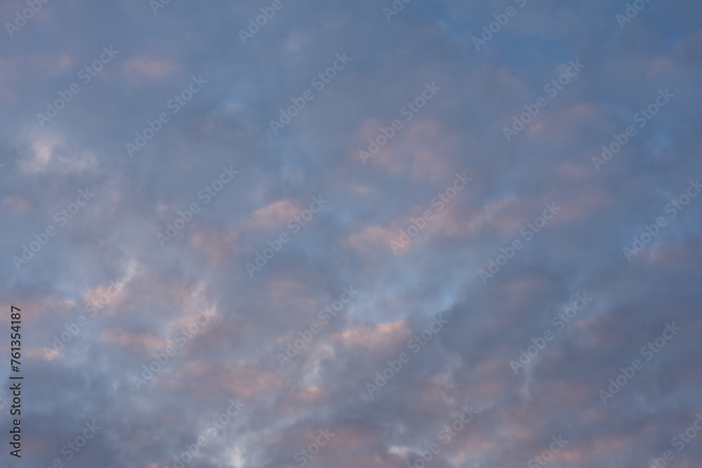 Photo texture of the sky with pink clouds during sunset.