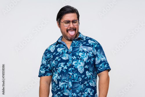 Wallpaper Mural Middle-aged man in a floral Hawaiian shirt sticking his tongue out, isolated on white, showing a disgusted reaction to something he ate. Torontodigital.ca