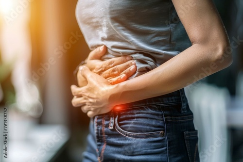 Woman suffering from intolerance or food poisoning, stomach ache, abdominal pain, colon problems, gastritis, diarrhea or inflammation. Patient's hand on the belly or abdomen.	 photo