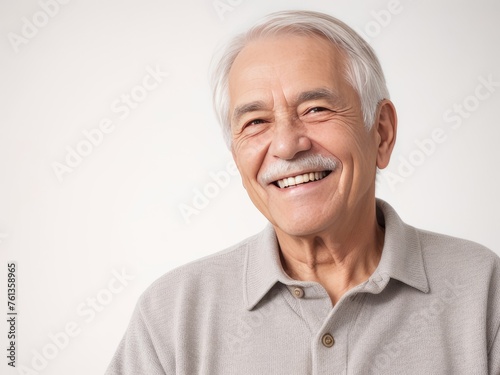 Portrait of a senior man with grey hair and a bright smile