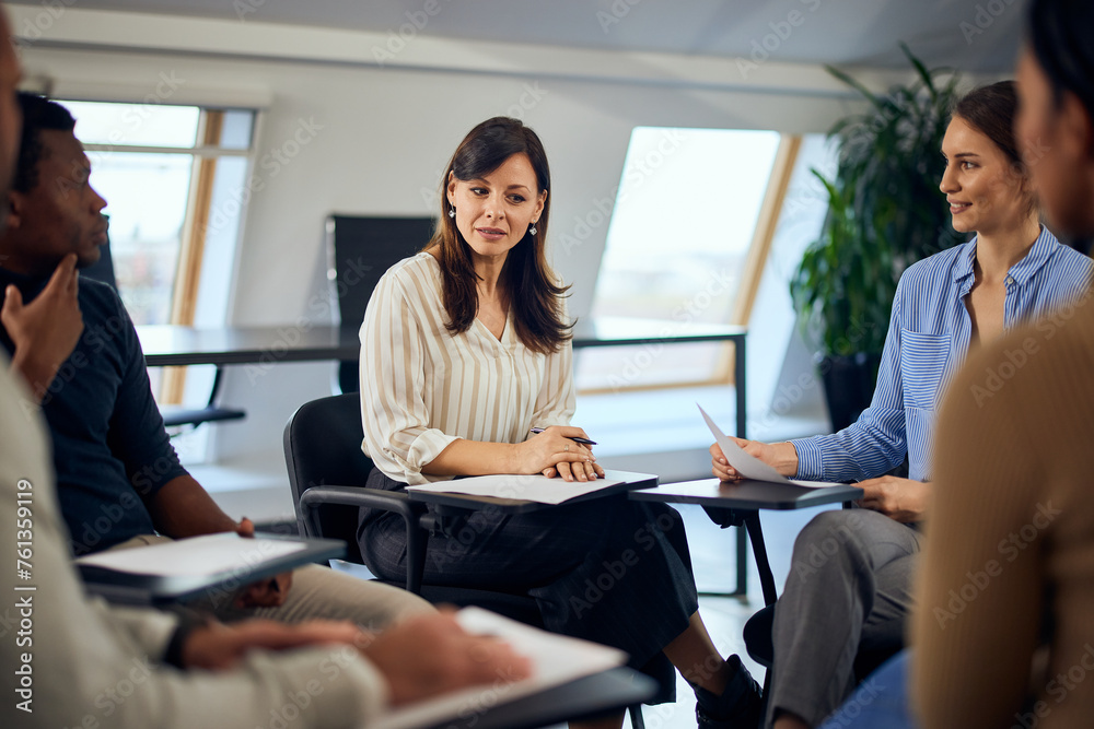 A group of people having a psychotherapy session and sitting in a circle. A group of people having a psychotherapy session and sitting in a circle.
