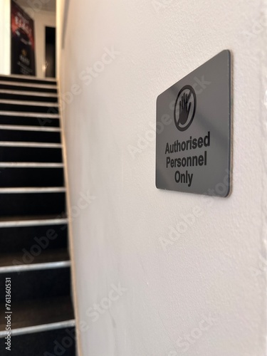 Vertical close up of authorised personnel only sign by the stairway