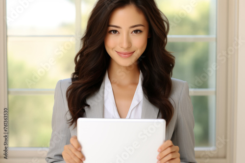 Woman in business suit holding tablet