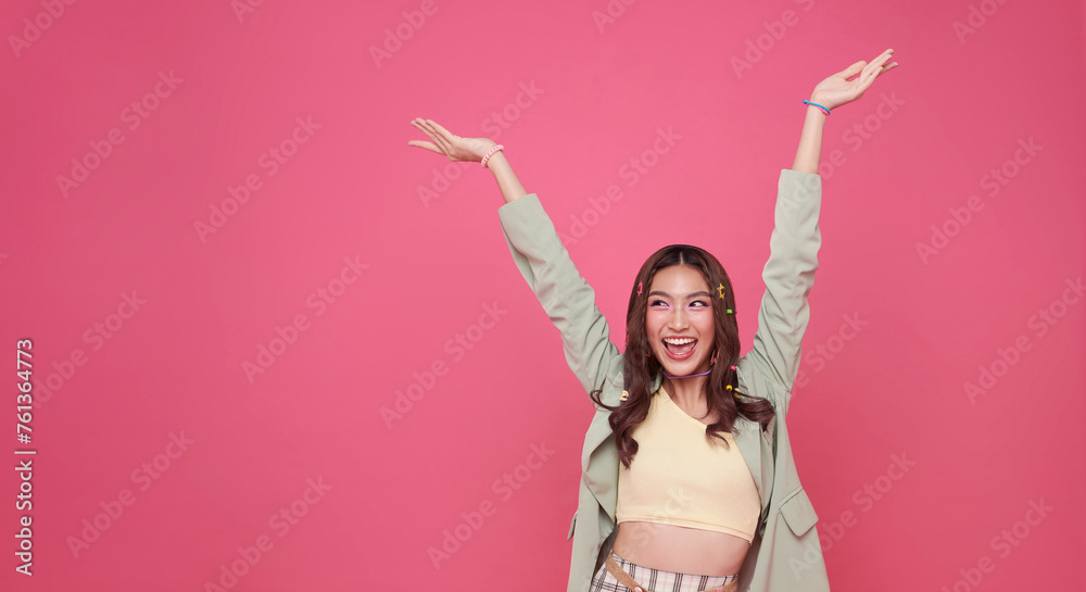 Happy ecstatic cheerful asian woman fist up raise win gesture isolated on pink copy space background. Happy ecstatic cheerful asian woman fist up raise win gesture isolated on pink copy space background.