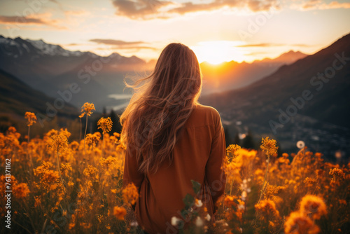Woman stands in field of yellow flowers