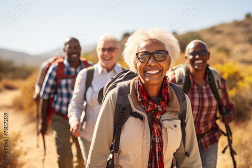 Group of older people are smiling and walking together in field
