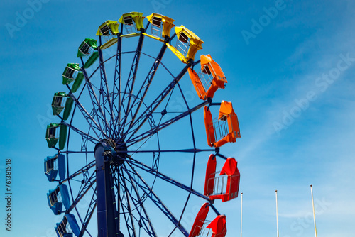 Colorful ride in motion in amusement park on sky background. © Elena Noeva