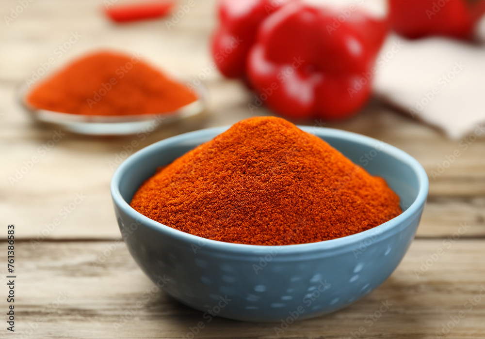 Paprika in a bowl on wooden table Paprika in a bowl on wooden table