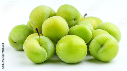 A pile of green plums isolated on a white background